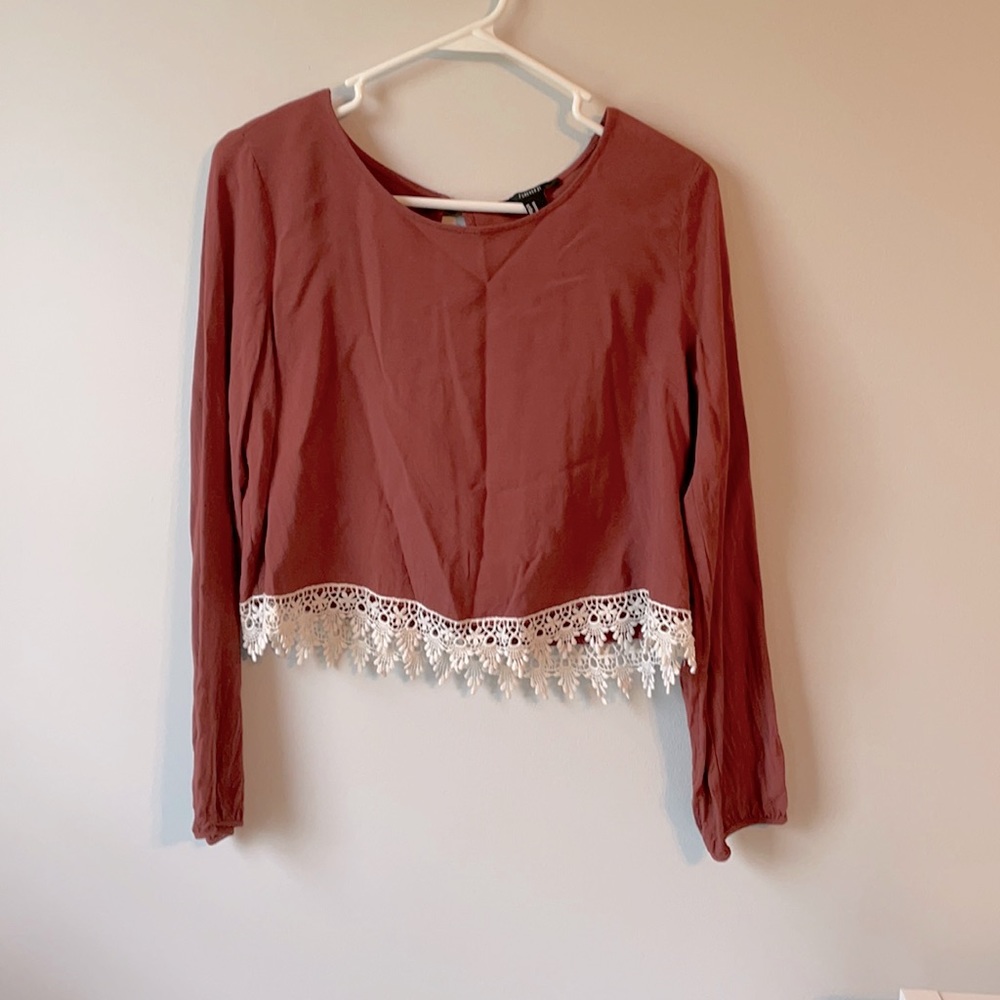 Long sleeve crop with lace detailing.